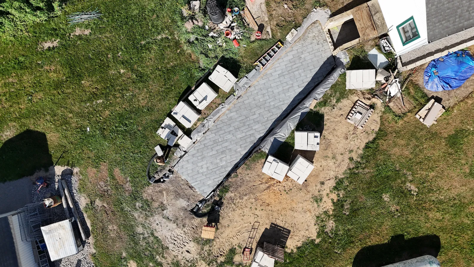 Swartz Creek — walkout basement entry under construction, block and masonry staged on site